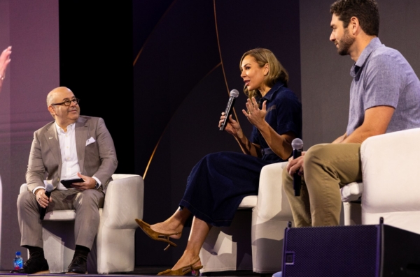 Group of speakers on a stage speaking to a crowd
