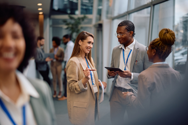 Multiracial group of business people talking in hallway of an office building